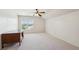 Bright, carpeted bedroom with a vaulted ceiling, ceiling fan, desk and a scenic window view at 558 Grand Ivey Pl, Dacula, GA 30019