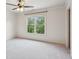 Bright bedroom with a ceiling fan and a large window providing ample natural light at 558 Grand Ivey Pl, Dacula, GA 30019