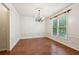 Bright dining room featuring classic chandelier, hardwood floors, and natural light at 558 Grand Ivey Pl, Dacula, GA 30019
