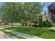 Inviting home with a manicured lawn and mature trees, offering great curb appeal on a sunny day at 558 Grand Ivey Pl, Dacula, GA 30019