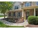 Close-up of a home's exterior, featuring brick accents, a covered entryway, and manicured landscaping at 558 Grand Ivey Pl, Dacula, GA 30019