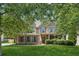 Charming two-story home with brick and siding, well-manicured lawn, and mature trees at 558 Grand Ivey Pl, Dacula, GA 30019