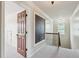 Hallway featuring a door, chalkboard, and staircase with decorative iron railing at 558 Grand Ivey Pl, Dacula, GA 30019
