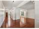 Spacious hallway featuring gleaming hardwood floors and elegant architectural details at 558 Grand Ivey Pl, Dacula, GA 30019