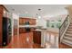 Spacious kitchen featuring hardwood floors, modern appliances, and a breakfast bar at 558 Grand Ivey Pl, Dacula, GA 30019