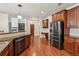 Modern kitchen featuring stainless steel appliances, granite countertops, and a convenient breakfast bar at 558 Grand Ivey Pl, Dacula, GA 30019
