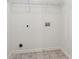 Neat and functional laundry room with white walls and tiled flooring at 558 Grand Ivey Pl, Dacula, GA 30019