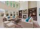 Cozy living room with stone fireplace, built-in shelving, and lots of natural light at 558 Grand Ivey Pl, Dacula, GA 30019