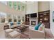 Cozy living room with stone fireplace, built-in shelving, and lots of natural light at 558 Grand Ivey Pl, Dacula, GA 30019
