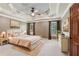 Inviting main bedroom with tray ceiling, plush carpet, and ample natural light at 558 Grand Ivey Pl, Dacula, GA 30019