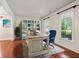 Inviting home office featuring custom built-ins, desk, wood floors, and natural light at 558 Grand Ivey Pl, Dacula, GA 30019