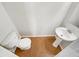 Cozy bathroom with a toilet and pedestal sink featuring tile floors at 2470 Arnold Mill Rd, Lawrenceville, GA 30044