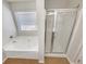Bathroom features a tub and a glass enclosed shower at 2470 Arnold Mill Rd, Lawrenceville, GA 30044