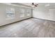 This is a main bedroom with multiple bright windows and a ceiling fan at 2470 Arnold Mill Rd, Lawrenceville, GA 30044