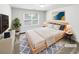 Virtually staged bedroom with large window, neutral tones, and modern decor at 2470 Arnold Mill Rd, Lawrenceville, GA 30044
