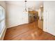 Dining area leading to kitchen, featuring natural light, hardwood floors, and neutral paint at 2470 Arnold Mill Rd, Lawrenceville, GA 30044