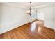 Dining room features wood flooring, wainscoting detail, and modern lighting fixture at 2470 Arnold Mill Rd, Lawrenceville, GA 30044