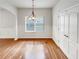 Dining area features wood floors, a modern chandelier, and natural light from a window at 2470 Arnold Mill Rd, Lawrenceville, GA 30044