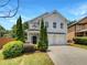 Charming two-story home with landscaped yard, two-car garage and inviting curb appeal at 2470 Arnold Mill Rd, Lawrenceville, GA 30044