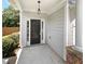 Inviting front entrance with a covered porch, black door, and stone accents at 2470 Arnold Mill Rd, Lawrenceville, GA 30044
