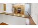 Open concept kitchen with stainless steel appliances and breakfast bar, flowing into the dining area at 2470 Arnold Mill Rd, Lawrenceville, GA 30044