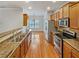 Well-lit kitchen featuring stainless steel appliances and wood cabinets at 2470 Arnold Mill Rd, Lawrenceville, GA 30044