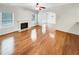 Bright living room featuring a fireplace, hardwood floors, and large windows at 2470 Arnold Mill Rd, Lawrenceville, GA 30044