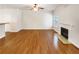 Spacious living room with a fireplace, hardwood floors, and neutral wall paint at 2470 Arnold Mill Rd, Lawrenceville, GA 30044