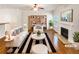 Staged living room with fireplace, hardwood floors, and built-in bookshelves at 2470 Arnold Mill Rd, Lawrenceville, GA 30044