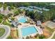 Aerial view showcases the community pool, playground, water slide, and tennis courts at 7048 Bennington Ln, Cumming, GA 30041