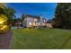 Spacious backyard with a large grassy area, a patio area and a view of the back of the home at 7048 Bennington Ln, Cumming, GA 30041