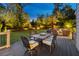 A relaxing backyard deck with an outdoor dining table and a cozy outdoor lounge area at 7048 Bennington Ln, Cumming, GA 30041