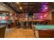 Home wet bar area with brick accents, a pool table, vintage décor, and bar stool seating at 7048 Bennington Ln, Cumming, GA 30041