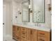 Bathroom featuring double vanity with modern faucets and decorative lighting at 7048 Bennington Ln, Cumming, GA 30041