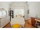 Bright bedroom with a vaulted ceiling, featuring a white bed, dresser, and charming decor at 7048 Bennington Ln, Cumming, GA 30041