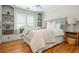 Bright bedroom with a window seat, built-in shelves, and a cozy bed with white linens at 7048 Bennington Ln, Cumming, GA 30041