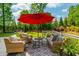 Inviting deck area with an umbrella, stylish outdoor furniture, and a patterned rug at 7048 Bennington Ln, Cumming, GA 30041