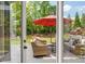 View through french doors onto the home's back deck with ample seating at 7048 Bennington Ln, Cumming, GA 30041