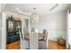 Dining room with modern light fixture, wainscoting detail, and built in cabinet at 7048 Bennington Ln, Cumming, GA 30041