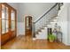 Elegant foyer with hardwood floors, staircase, and an open view at 7048 Bennington Ln, Cumming, GA 30041