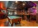 Basement recreation room featuring a wet bar, a pool table, and vintage signage and decor at 7048 Bennington Ln, Cumming, GA 30041