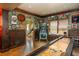 Spacious game room boasts shuffleboard, pinball machine, and decorative sports memorabilia for entertainment at 7048 Bennington Ln, Cumming, GA 30041