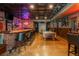 A fully equipped basement entertainment area featuring a golf simulator and a wet bar at 7048 Bennington Ln, Cumming, GA 30041