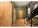 Hallway with olive green walls, wood trim, sports chair and wooden doors, and a concrete floor at 7048 Bennington Ln, Cumming, GA 30041