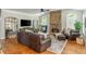 Spacious living room with comfortable seating, hardwood floors and stone fireplace at 7048 Bennington Ln, Cumming, GA 30041