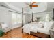 Primary bedroom with four-poster bed, tray ceiling, and large windows at 7048 Bennington Ln, Cumming, GA 30041