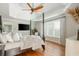 Primary bedroom features a four-poster bed, hardwood floors, and plantation shutters at 7048 Bennington Ln, Cumming, GA 30041