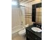Bathroom features tile flooring, bathtub, sink, and lots of storage with modern finishes at 1038 Island View Ct, Buford, GA 30518