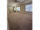 A large bedroom with tray ceiling, carpet flooring, and natural light from a window at 1038 Island View Ct, Buford, GA 30518
