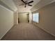 A large bedroom with tray ceiling, carpet flooring, and natural light from a window at 1038 Island View Ct, Buford, GA 30518